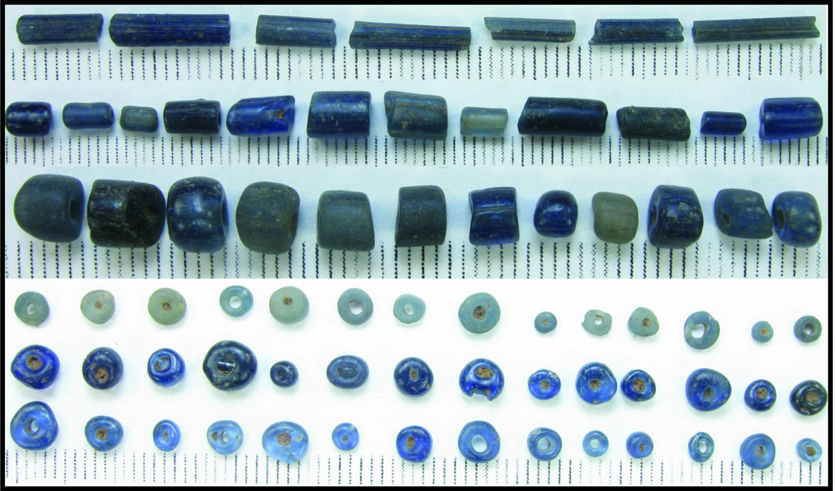 Excavated blue glass beads from Igbo-Olokun on a measurement grid