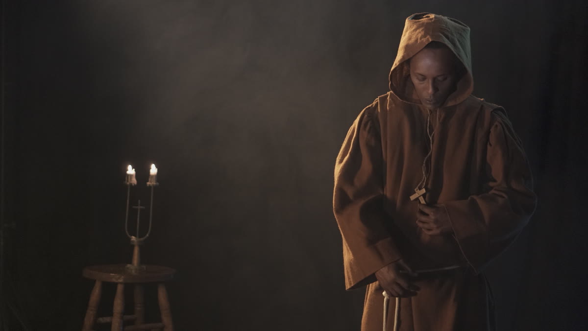Still from 'We Were Here' of a Black friar by candlelight