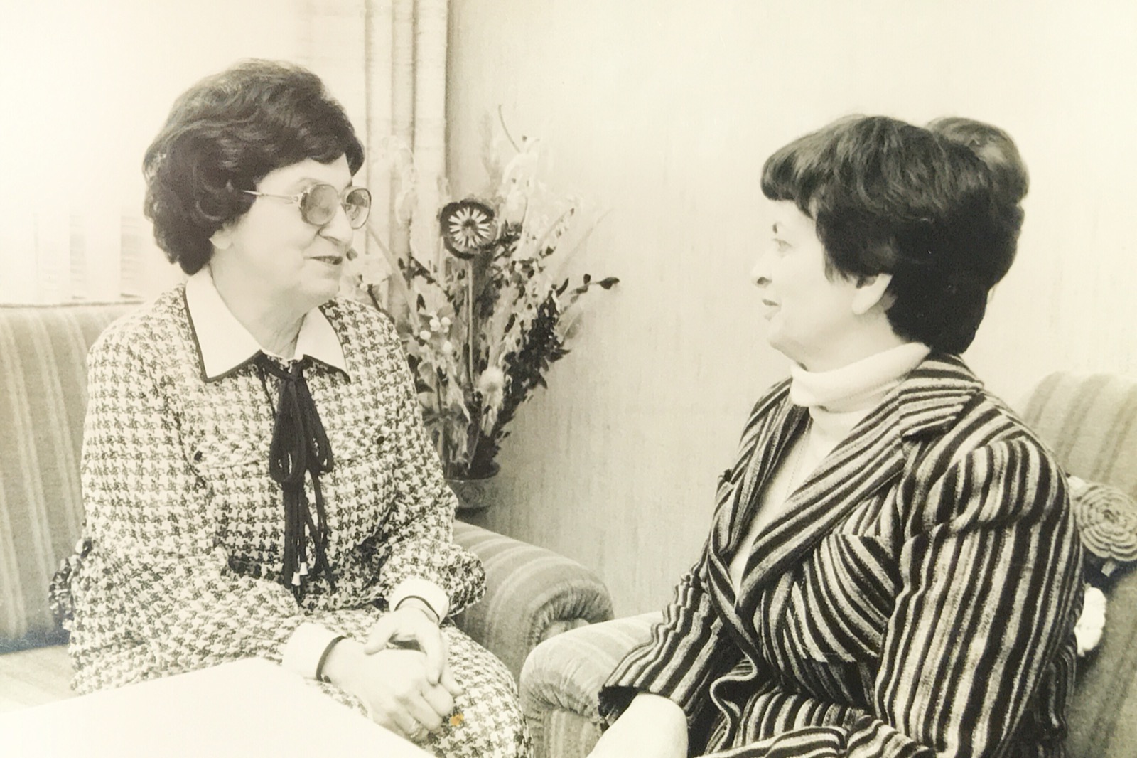 Photograph of two older women seated together in conversation
